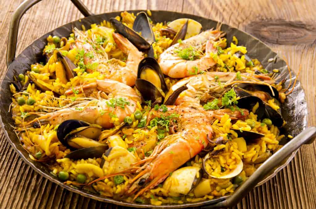 Close-up of seafood paella in a wrought-iron pan
