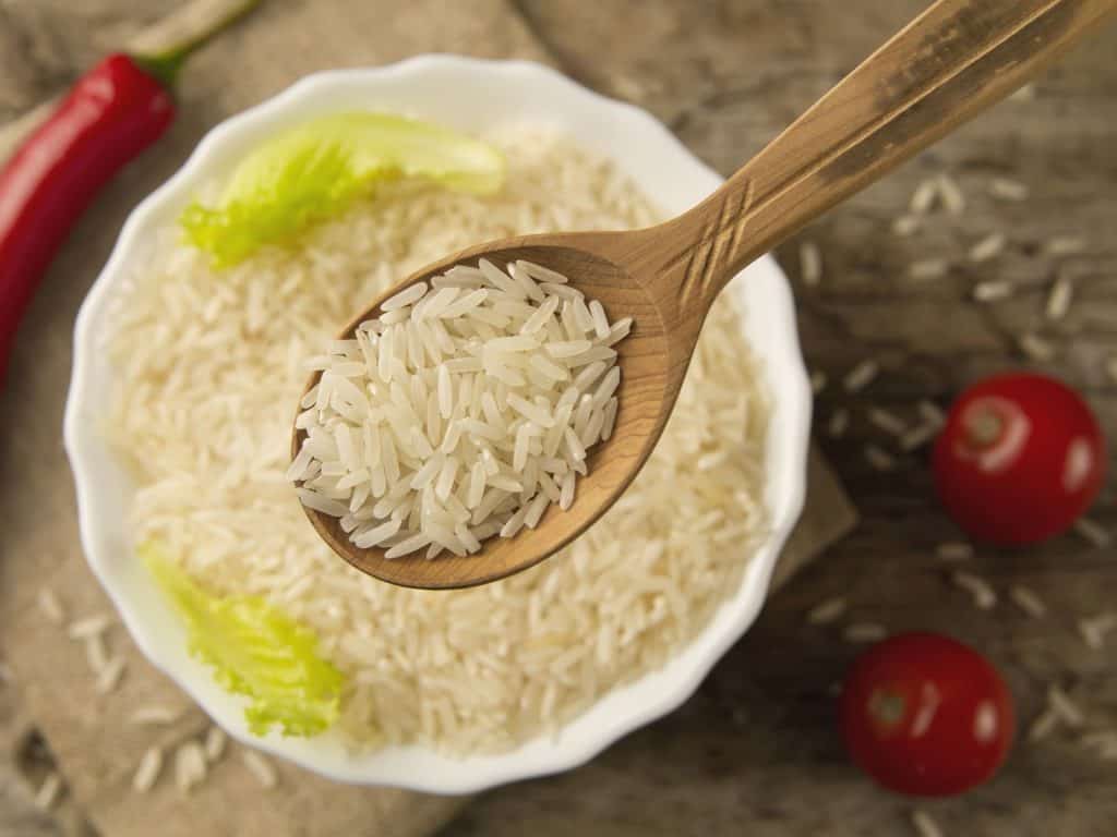 long grain rice in a wooden spoon