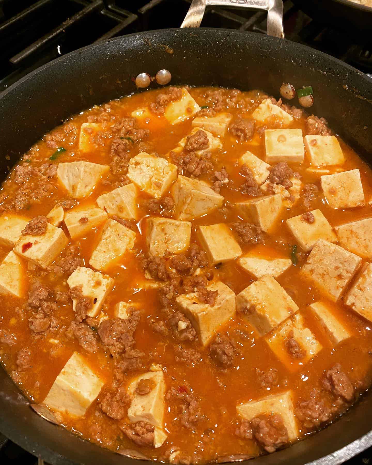 cooking-mapo-tofu simmering mapo tofu