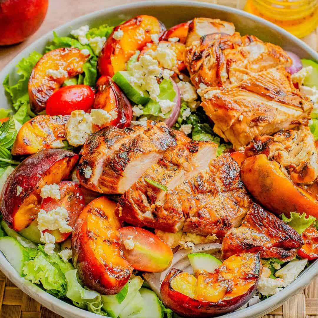 grilled chicken served with peach and burrata salad