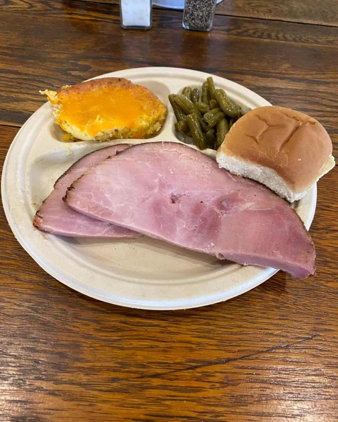 a serving of honey-baked ham with sides