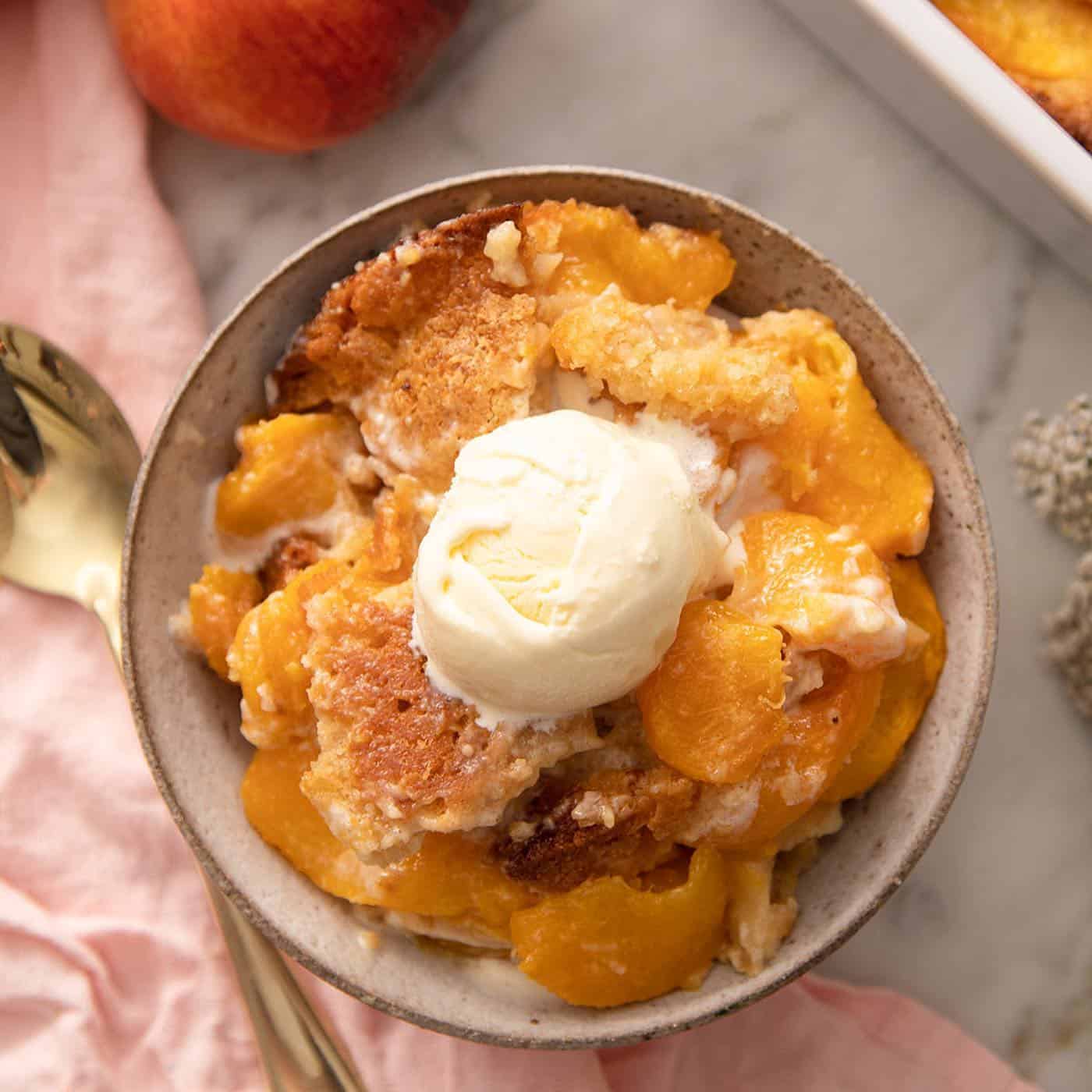 peach cobbler served with ice cream on top