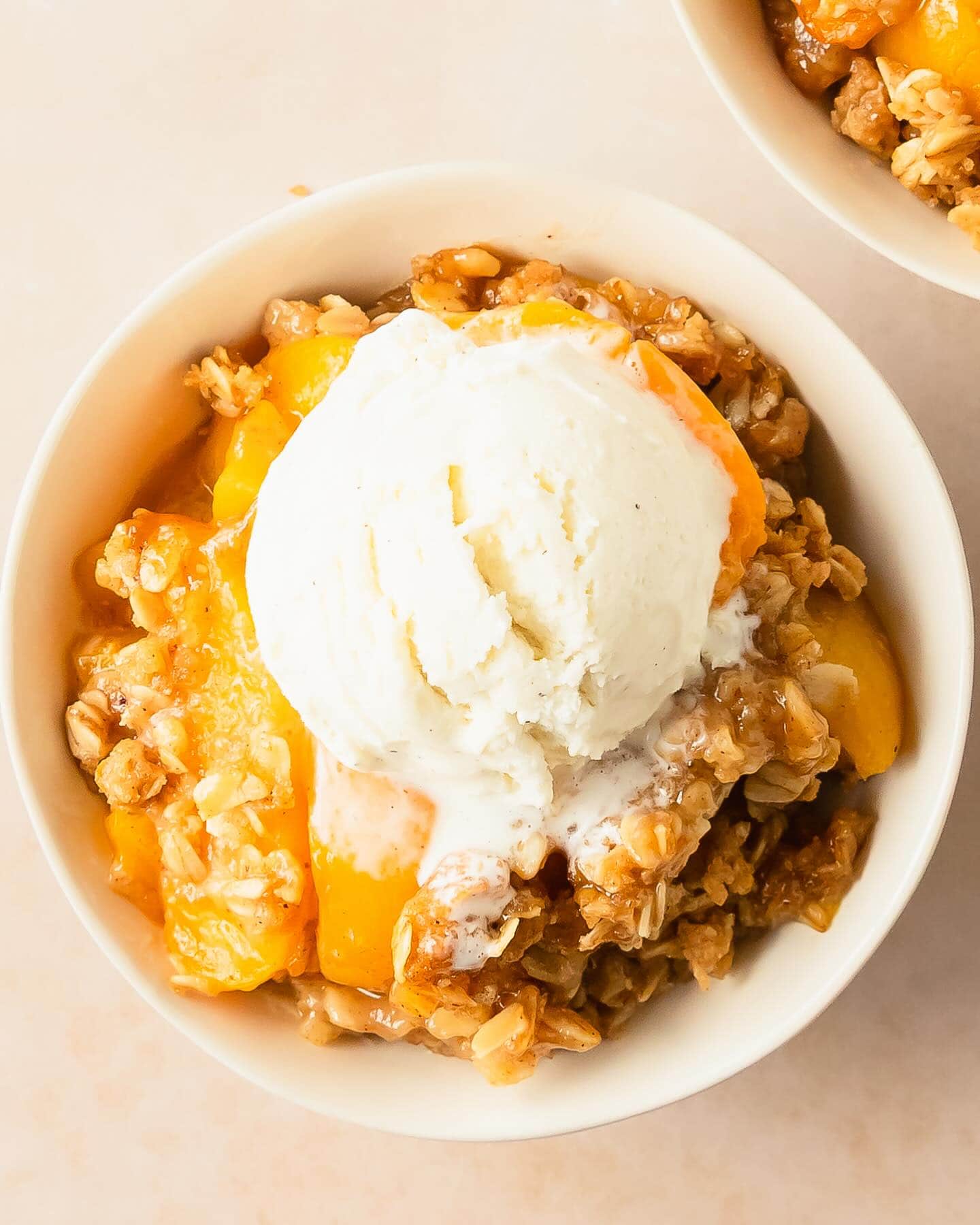 peach-crisp-serving a serving of peach crisp with vanilla ice cream on top