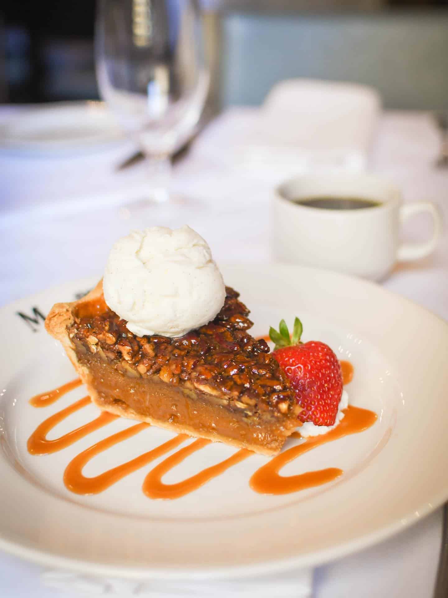 serving-pecan-pie pecan pie served with vanilla ice cream and caramel sauce