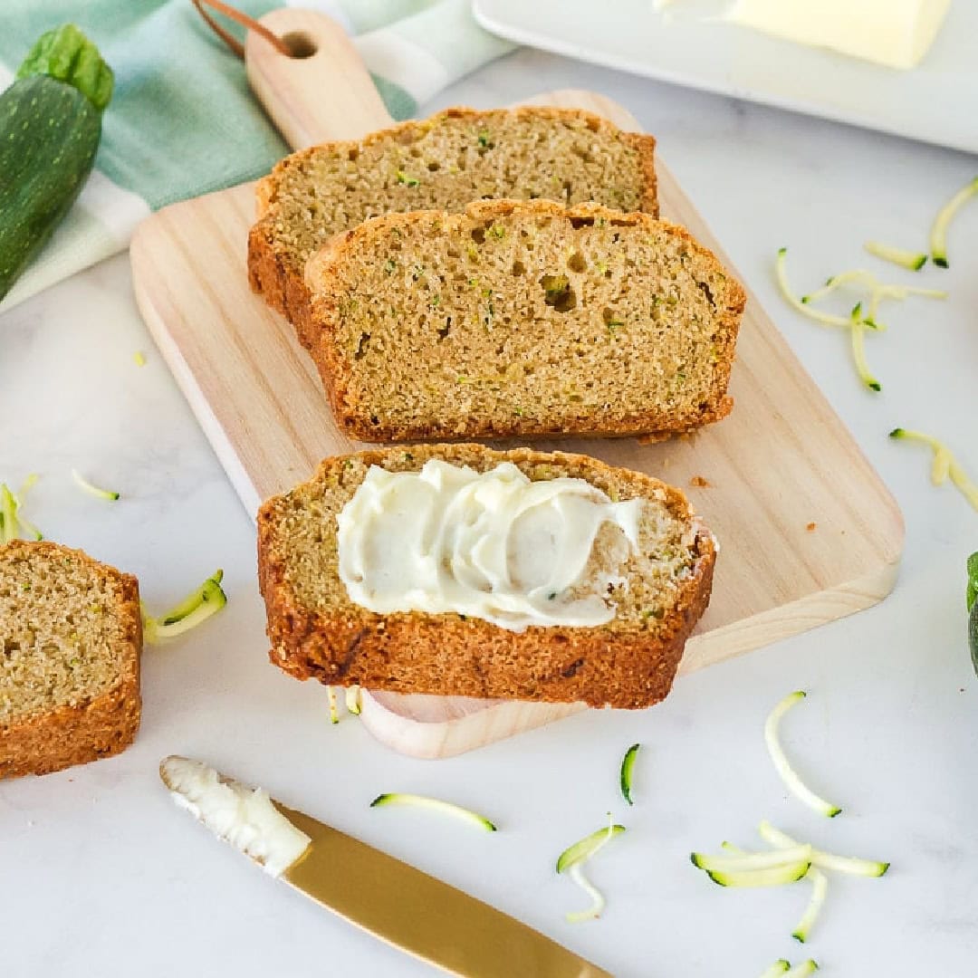 sliced-zucchini-bread slices of zucchini bread served with butter