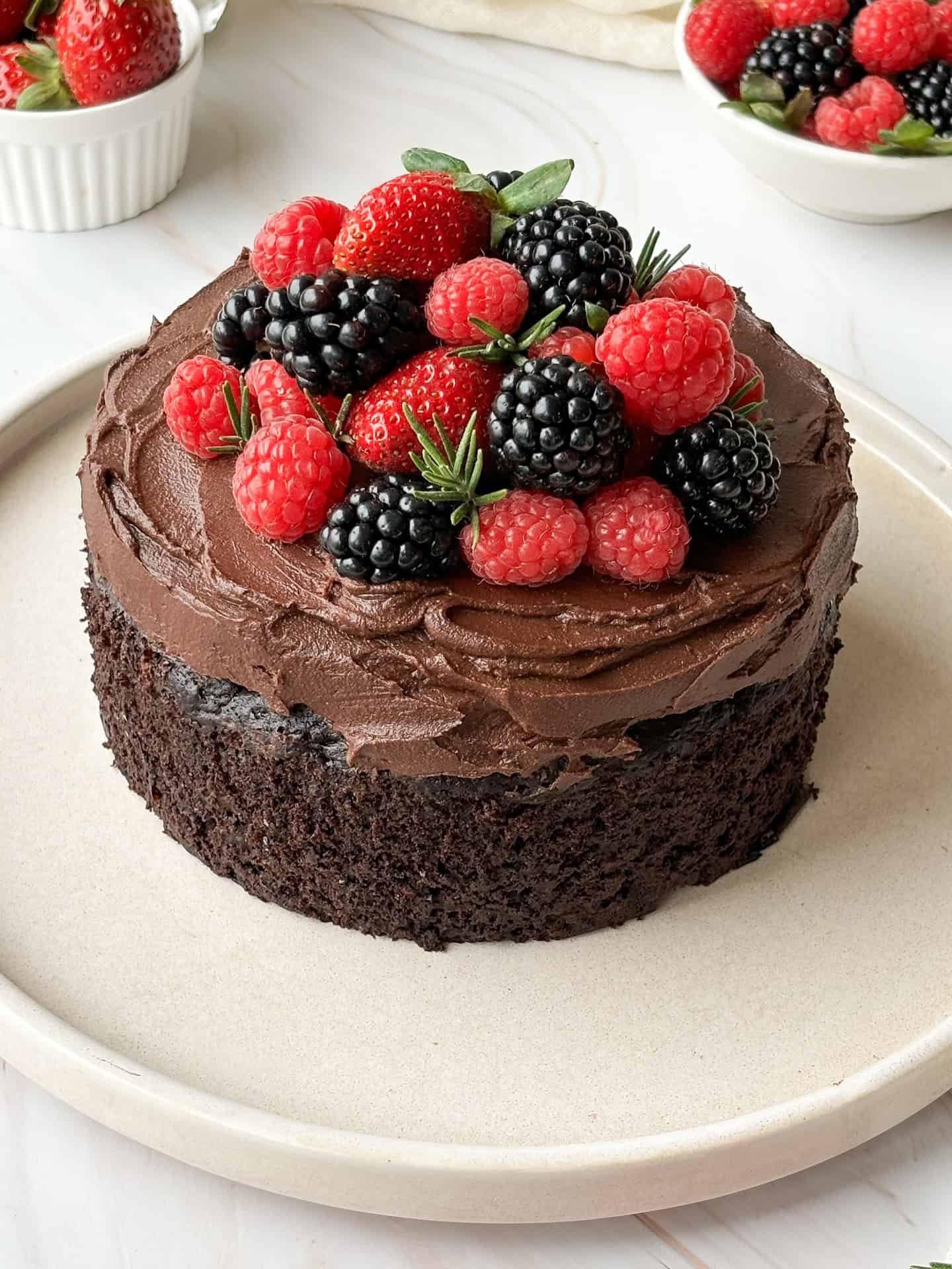 chocolate zucchini cake with chocolate ganache and berries on top